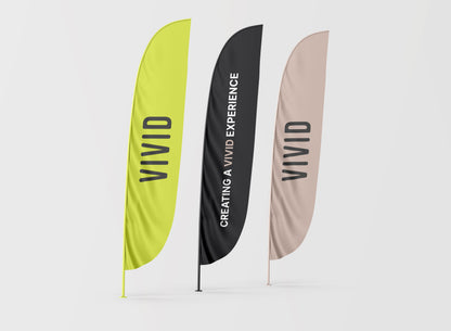 VIVID custom feather flag — lifestyle view showing flag displayed outdoors